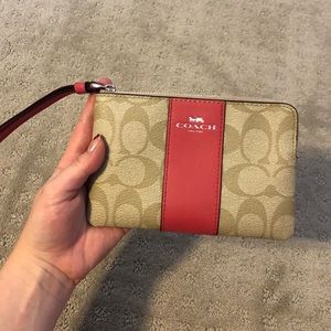 Small pink and tan Coach wristlet
